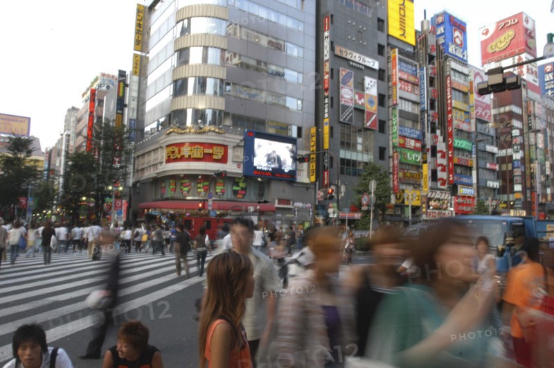 JAPAN, Honshu, Tokyo, Shinjuku. Entertainment district Kabukicho on Saturday evening with pedestrian crossing of Yasukuni-dori in the foreground