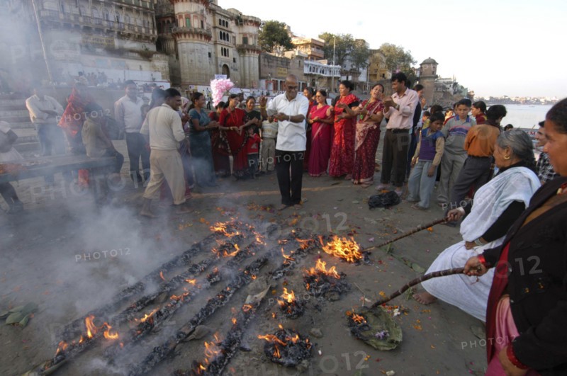 INDIA, Uttar Pradesh, Varanasi , Nepali man dances at a Hindu ceremony at Asi Ghat beside the Ganges River