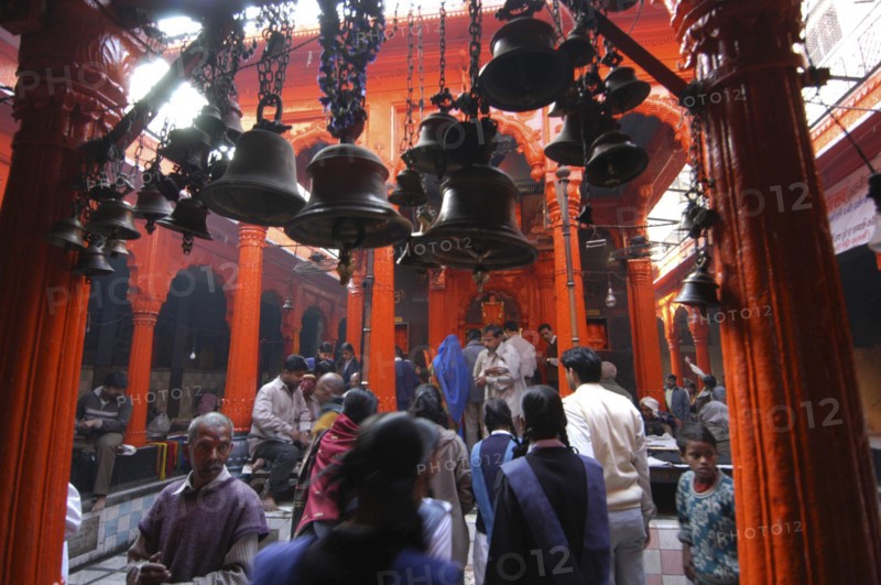 INDIA, Uttar Pradesh, Varanasi , Kala Bhairava Temple. Temple interior with bells and worshippers
