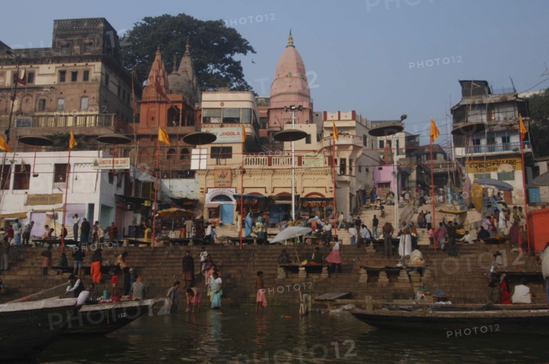 INDIA, Uttar Pradesh, Varanasi, Dashaswamedh Ghat with early morning pilgrims bathing in the Ganges River