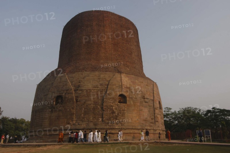 INDIA, Uttar Pradesh, Sarnath, Pilgrims from Thailand walk around Dhamek Stupa led by monks