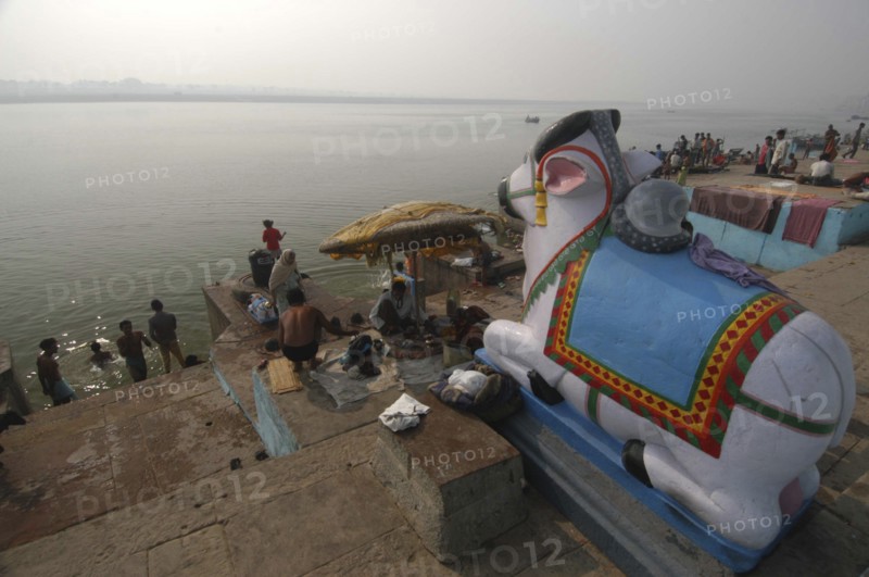 INDIA, Uttar Pradesh, Varanasi, Figure of Shivas bull Nandi overlooking the steps of Ghai Ghat by the Ganges River