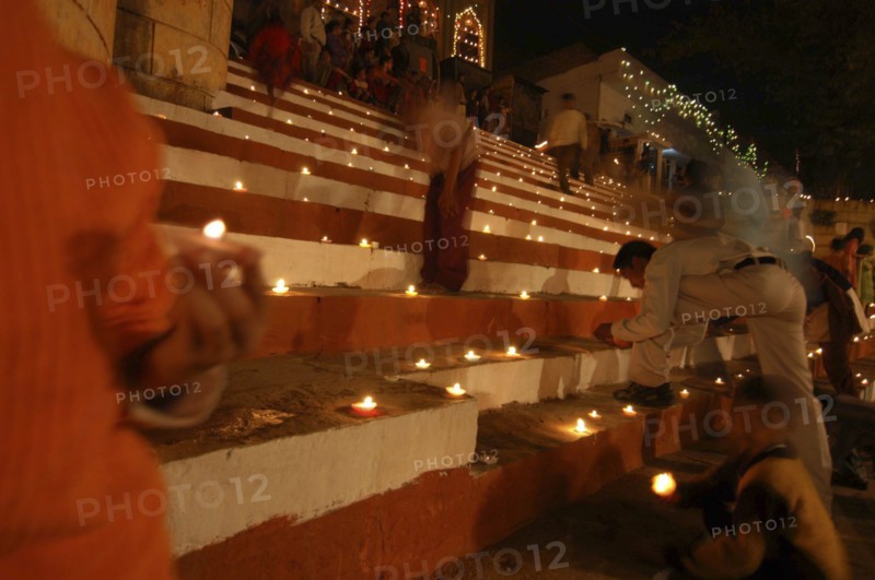 INDIA, Uttar Pradesh, Varanasi, Deep Diwali Festival with oil lamps on steps leading down to the Ganges River