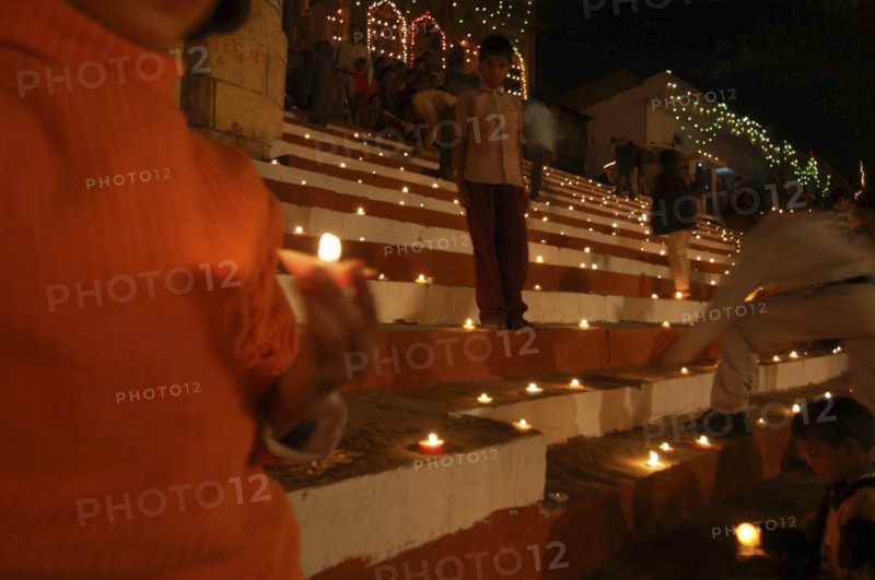INDIA, Uttar Pradesh, Varanasi, Deep Diwali festival with oil lamps on the steps leading down to the Ganges River
