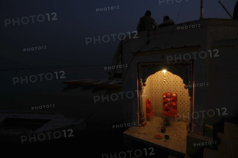INDIA, Uttar Pradesh, Varanasi, Near Hanuman Ghat. A Hanuman Shrine on the Ganges River at night