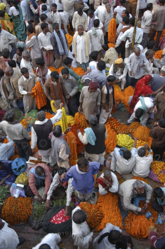 INDIA, Uttar Pradesh, Varanasi, View looking down on busy flower market with a majority of male vendors selling mostly marigolds