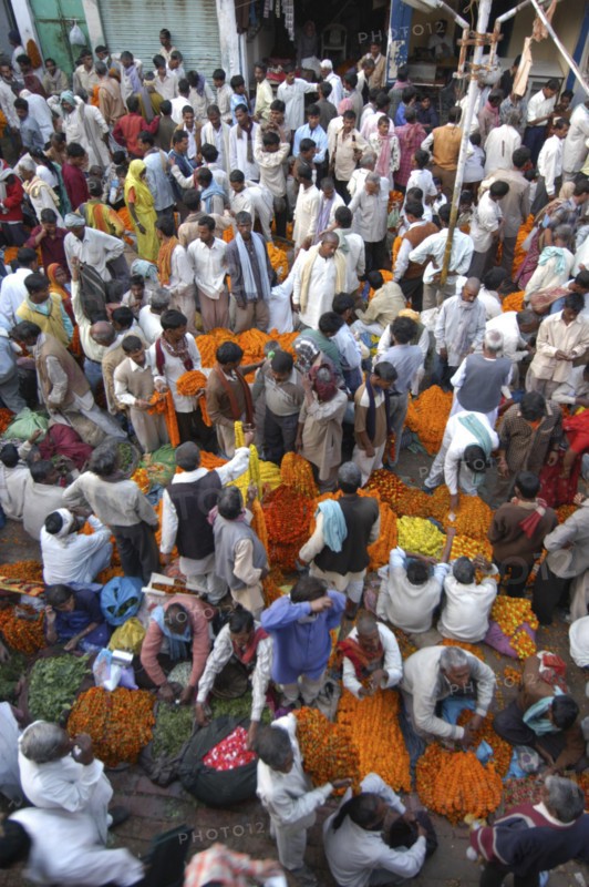 INDIA, Uttar Pradesh, Varanasi, View looking down on busy flower market with a majority of male vendors selling mostly marigolds