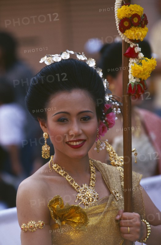 THAILAND, Chiang Mai, Portrait of young woman marching in the Flower Festival parade