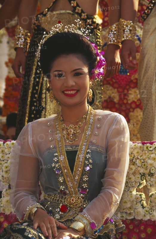 THAILAND, Chiang Mai, Portrait of young woman riding the beauty contest float in the Flower Festival parade