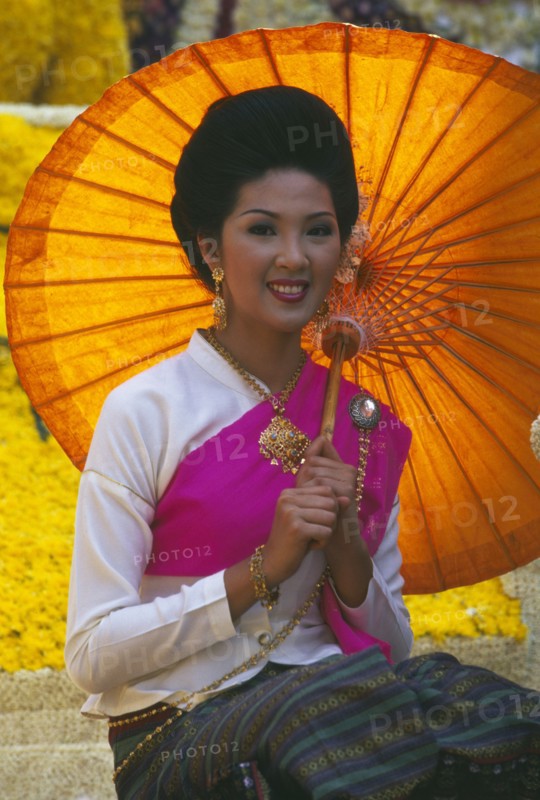 THAILAND, Chiang Mai, Portrait of young woman riding the beauty contest float in the Flower Festival parade
