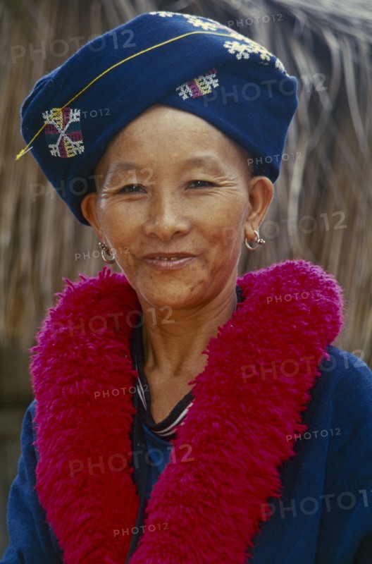 THAILAND, Chiang Rai, Mae Chan District. Portrait of a Iu Mien woman in traditional attire at her Village Baan Lao Shi Kuay