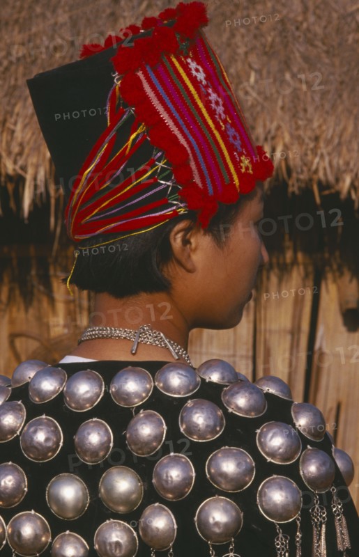 THAILAND, Chiang Mai Province, Muang Nga, Back view of a Jinghpaw woman in traditional jacket and hat