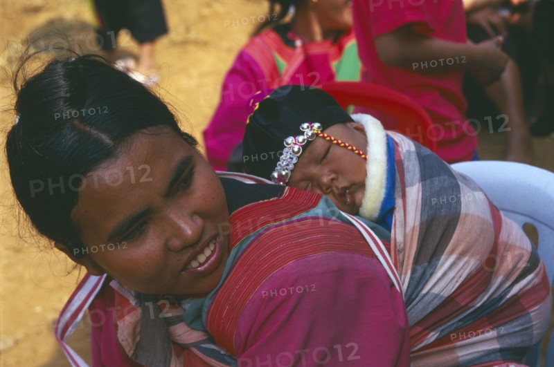 THAILAND, Chiang Rai, Doi Lan, Lisu woman with her infant son carried papoose style on her back