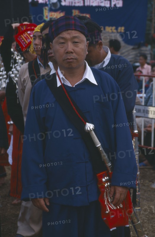 THAILAND, Chiang Mai Province, Samathi Mai, Kachin Manou. Kachin elder in line awaiting the start of a Manou dance