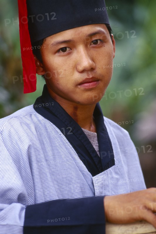 MYANMAR, Kachin State, Manhkring, Portrait of a Lisu man with Mahkhong marks on his neck in traditional Lisu attire of the Putao area