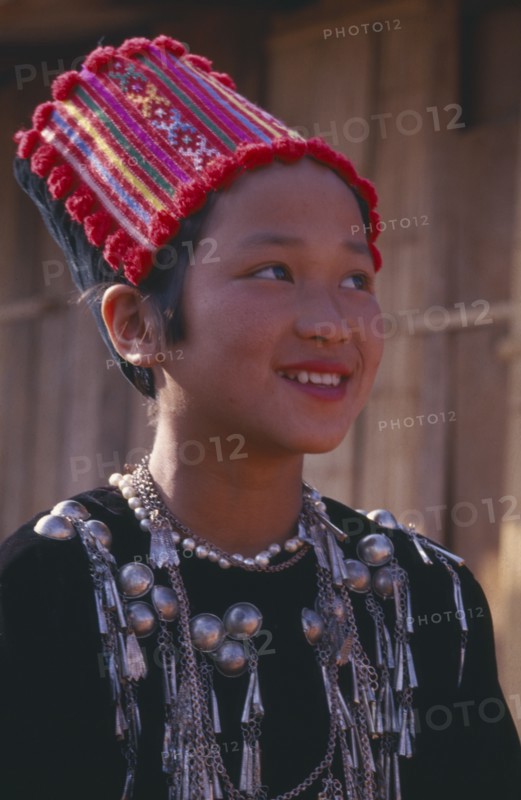 THAILAND, Chiang Mai Province, Muang Nga, Portrait of a Jinghpaw girl wearing traditional womans jacket and hat