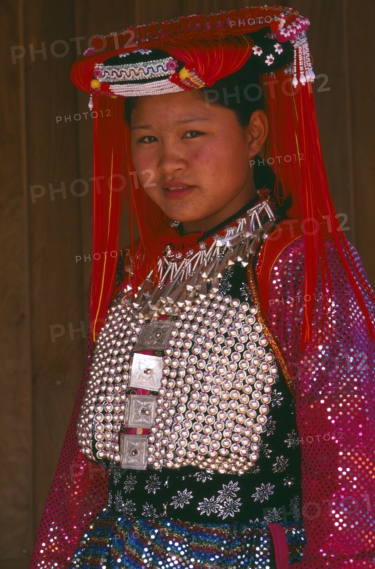 THAILAND, Chiang Rai Province, Doi Lan, Young Lisu woman in her New Year finery prior to going to a New Year dance