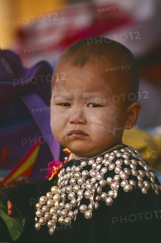 THAILAND, Chiang Rai Province, Huai Khrai, Portrait of a Lisu infant boy wearing New Year silver studded jacket