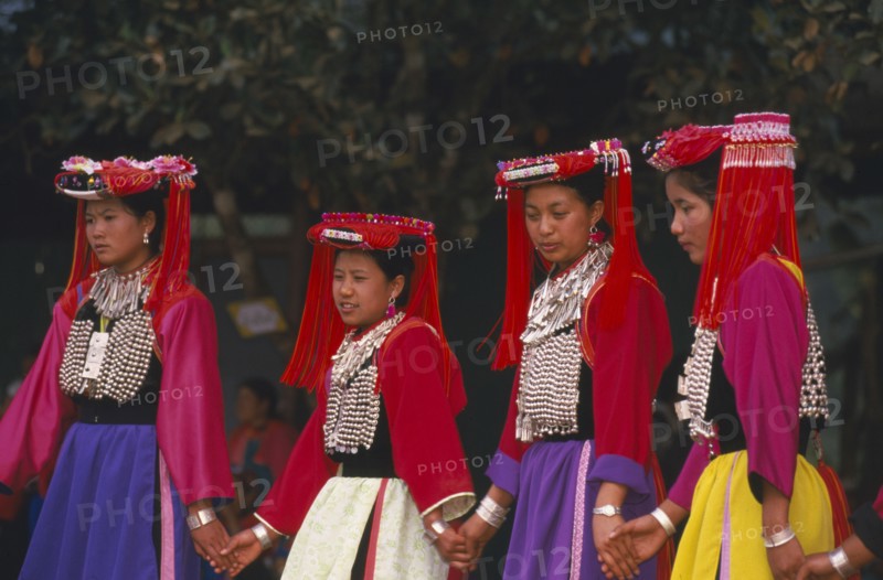 THAILAND, Chiang Rai Province, Huai Khrai, Young Lisu women dancing in their New Year finery