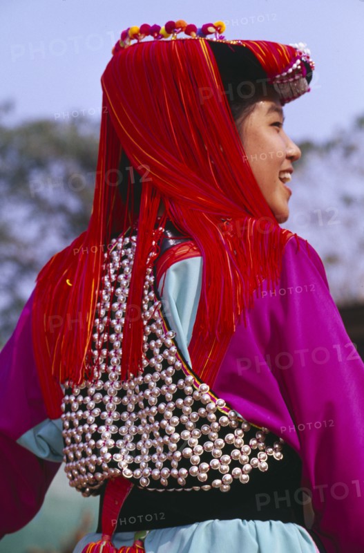 THAILAND, Chiang Rai Province, Doi Lan, Back view of a young Lisu woman wearing her New Year finery