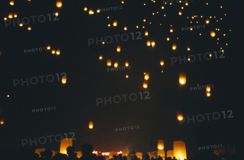 THAILAND, Chiang Mai, San Sai District, Loi Krathong Festival aka Yi Peng. People launching hot air balloons into the night sky