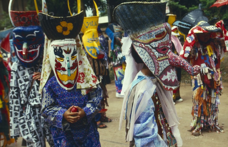 THAILAND, Loei Province, Dan Sai, Phi Ta Khon or Spirit Festival. Group of spirits in costume and masks at Wat Phon Chai