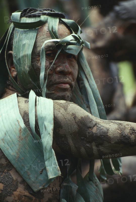 THAILAND, Loei Province, Dan Sai, Phi Ta Khon or Spirit Festival. Mud man covered in a layer of mud and leaves