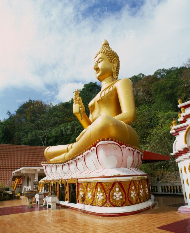 THAILAND, Phuket Province, Phuket, Big Buddha Temple.  Large seated golden Buddha figure in temple courtyard.