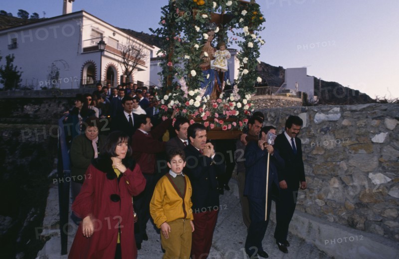SPAIN, Andalucia, Festivals, Christmas procession through village carrying garlanded statue of the Virgin and Child.
