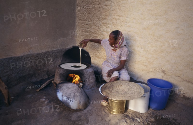 ERITREA, Keren, "Woman cooking injera, a type of sour, flat bread that accompanies most meals."