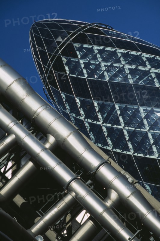 ENGLAND , London, Close cropped angled view of the Swiss Re Tower with other architecture in front