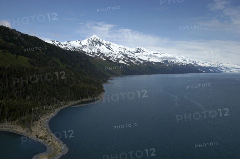USA, Alaska, Prince William Sound, View along the coast toward snow capped mountain peaks