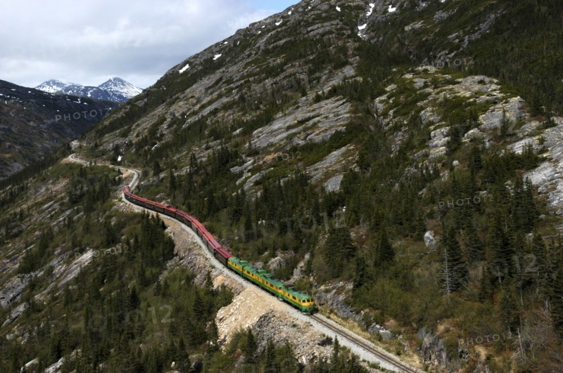 USA, Alaska, Skagway, White Pass and Yukon Railway travelling along a mountainside