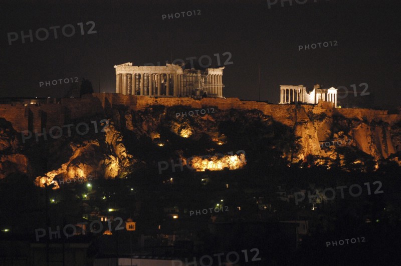 GREECE, Athens, View toward the hilltop Acropolis with the Parthenon and other ruins illuminated at night