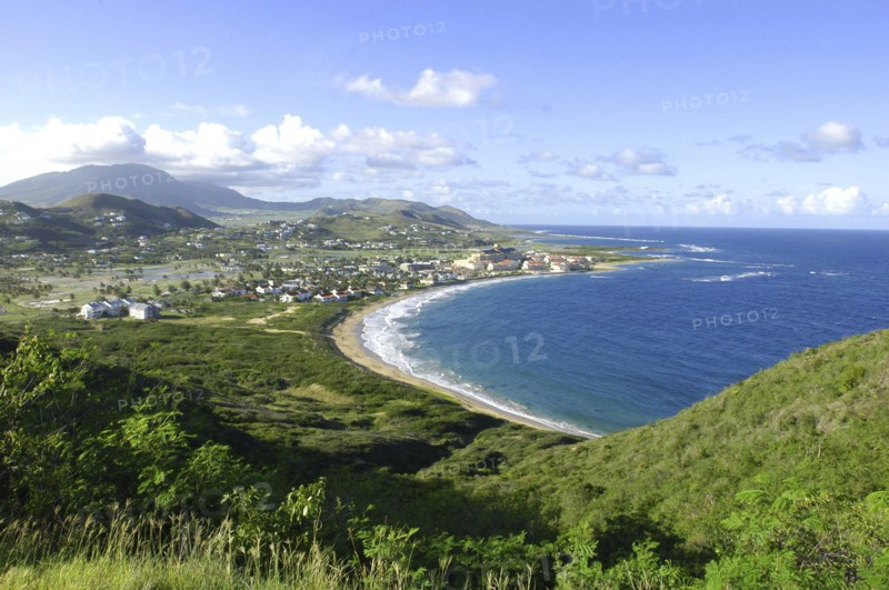 WEST INDIES, St Kitts, View over green hills and coastline with sandy bay