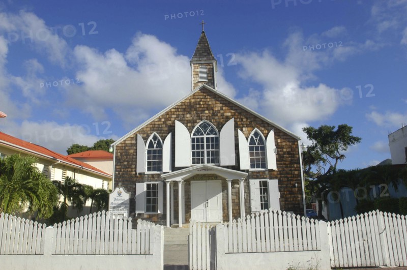 WEST INDIES, St Martin, Small brick church with white shuttered windows and surrounding picket fence