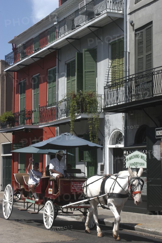 USA, Louisiana, New Orleans, French Quarter. Horse drawn carriage with passenger