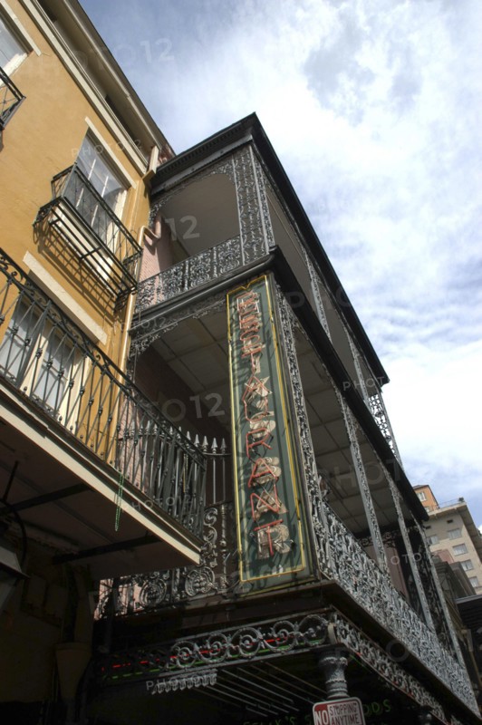 USA, Louisiana, New Orleans, French Quarter. Angled view looking up at ornate ironwork balcony of a restaurant