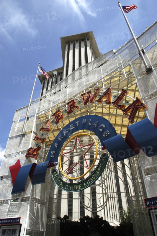 USA, Louisiana, New Orleans, Angled view looking up athe Riverwalk Marketplace entrance sign with highrise buildings behind