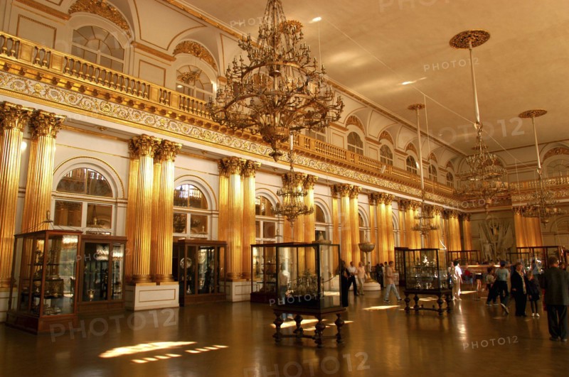 RUSSIA, St Petersburg, The Hermitage exhibition hall with encased exhibits and hanging chandeliers