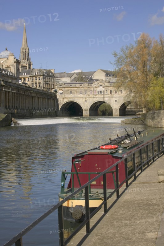 ENGLAND, Bath, View of Pulteney Bridge with canal boat in foreground on the River Avon.