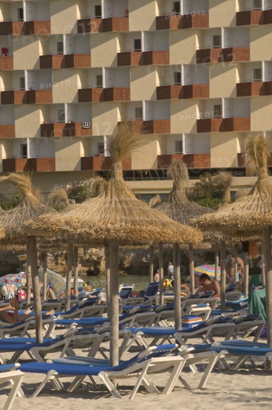 SPAIN, Balearic Islands, Majorca , Sun loungers and parasols on the beach at Palma Nova.