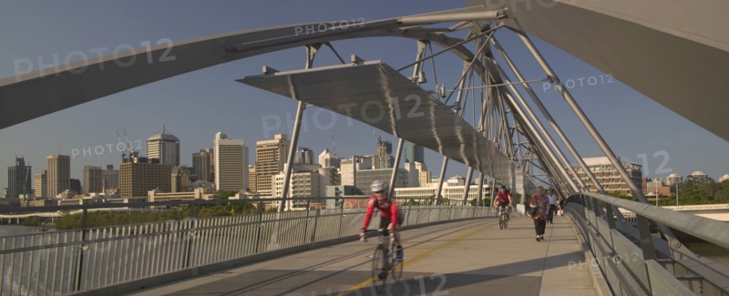 AUSTRALIA, Queensland, Brisbane, Cyclists and pedestrians crossing the Goodwill Bridge.