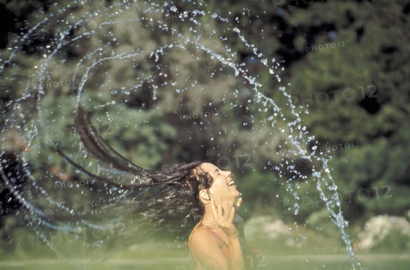 PEOPLE, Women, Woman in a swimming pool flings her wet hair over her head