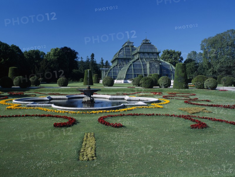AUSTRIA, Vienna, Schonbrunn Palace formal gardens with fountain and the Palm House