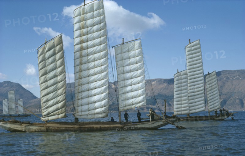 CHINA, Yunnan Province, Kunming Lake, Fishing boats in full sail.