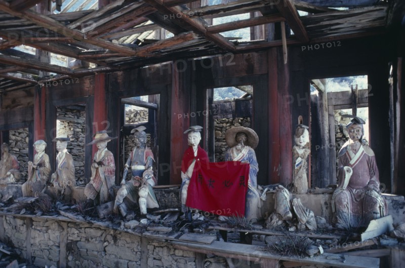 CHINA, Sichuan Province, Huanglong Valley, Yellow Dragon temple.  Dilapidated structure and damaged statues.