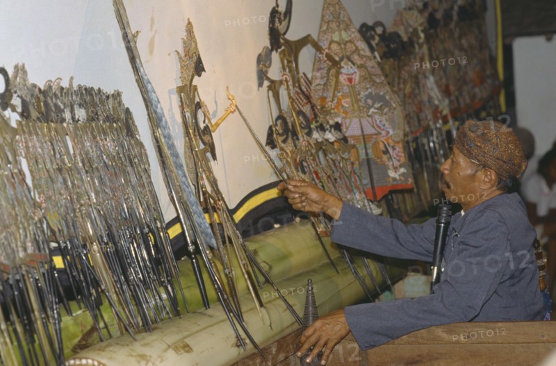 INDONESIA, Java, Shadow puppeteer near Borobudur.