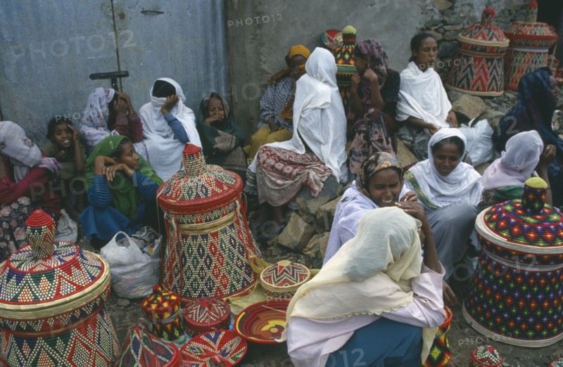 ETHIOPIA, Gonder, Women selling colourful woven baskets at market.