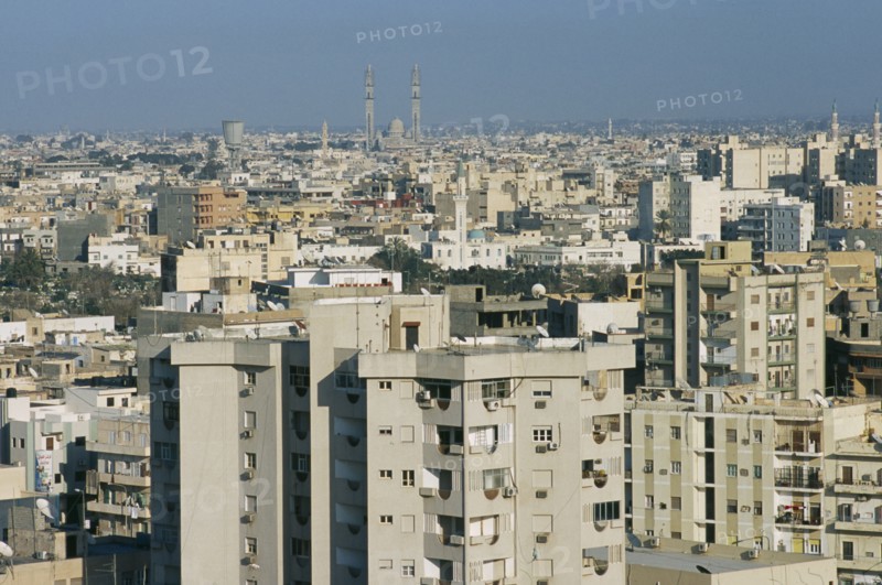 LIBYA, Tripoli, Cityscape view over housing and urban architecture toward distant Mosque